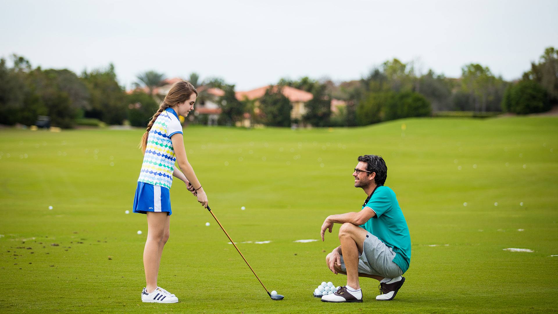 Man and girl golfing