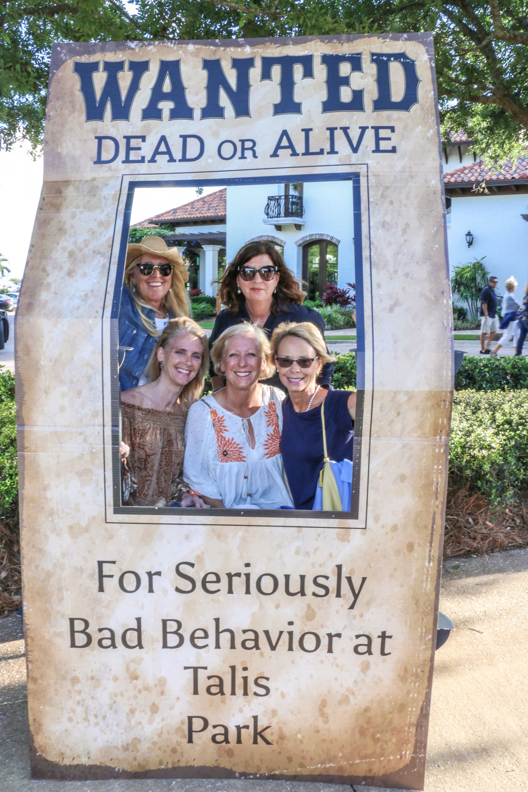 A group inside a standee reading: Wanted dead or alive for seriously bad behavior at Talis Park