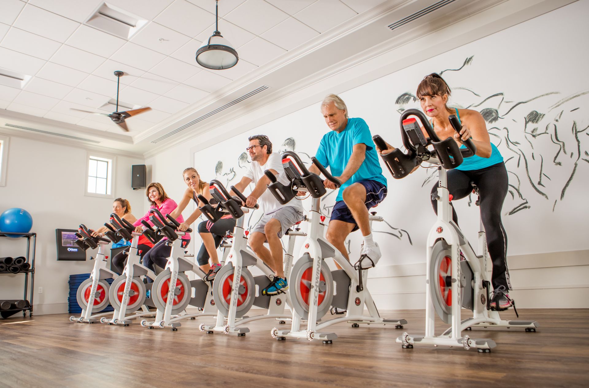 People cycling inside a fitness center inside Talis Park Naples FL
